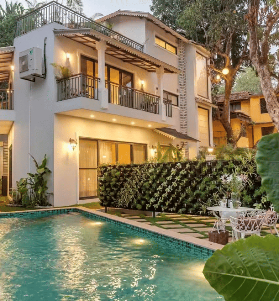 Exterior view of the villa with a pool surrounded by lush plants at Lime Tree Villa with Private Pool | Luxury Stay in Goa.